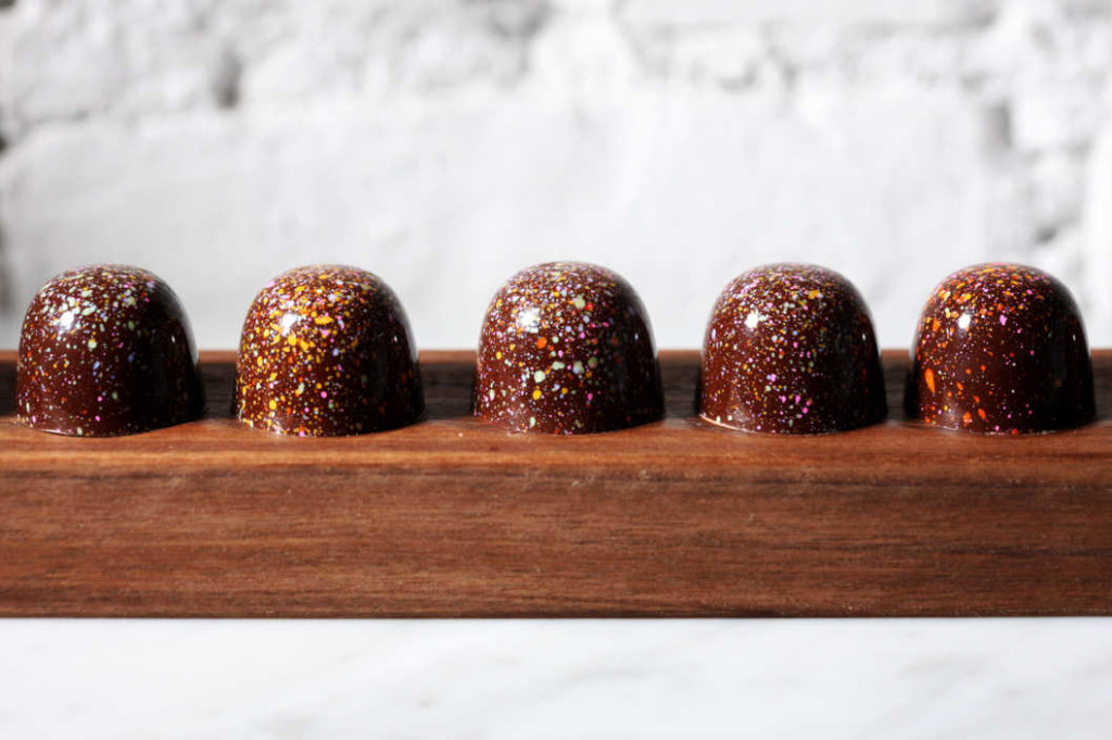 "New York, New York" bonbons (Dark chocolate filled with candied peanuts, pretzel pieces, and caramel) Photograph by Melissa Hom